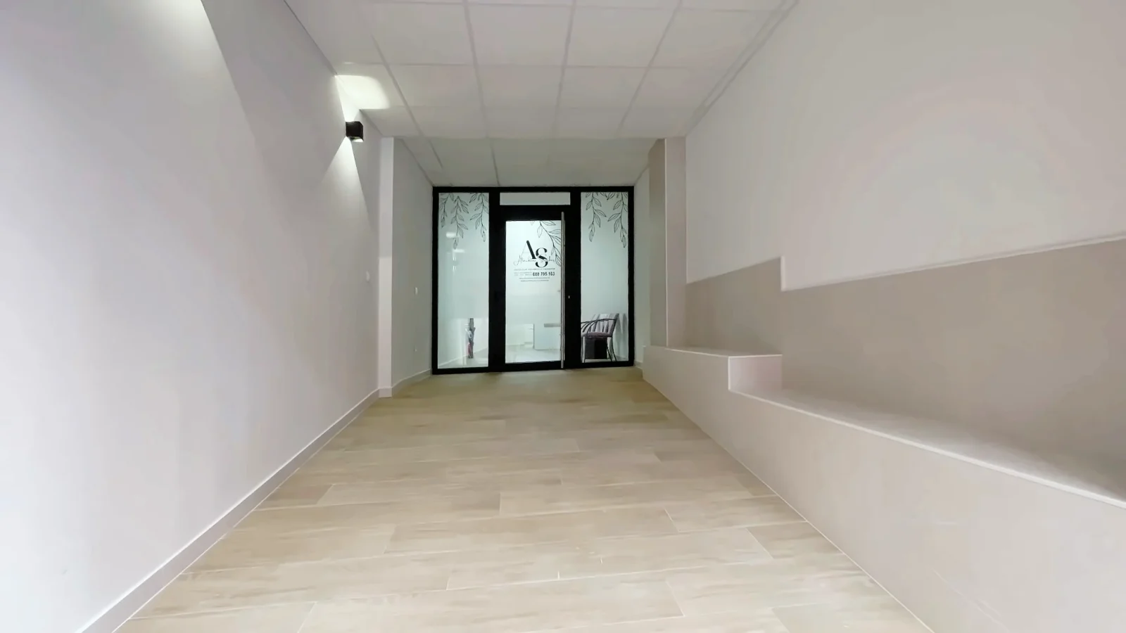 Entrance corridor from the street, with a continuous plinth